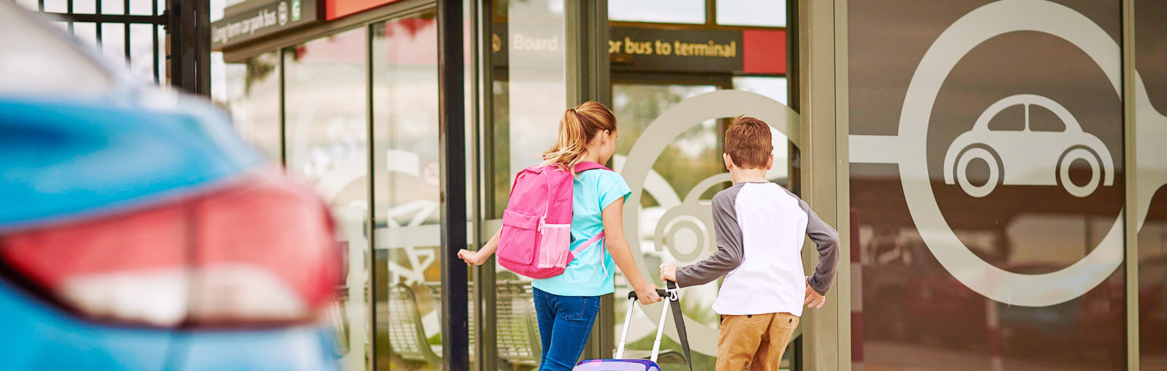 Kids running into the Long Term car park bus station